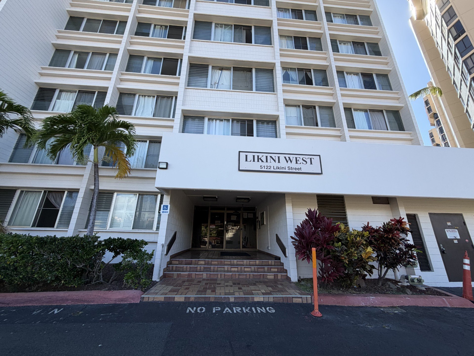 The front of a white building with the name Likini West on it.